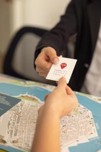 a person holding a piece of paper with a map at Ostello della Gioventù Brindisi in Brindisi