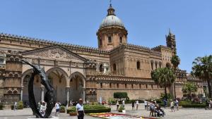 a large building with a statue in front of it at BBX Palermo Centro in Palermo