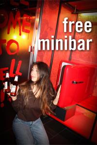 a woman standing in front of a red suitcase at 25hours Hotel Florence Piazza San Paolino in Florence