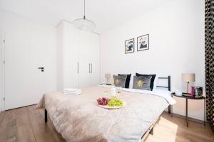 Łóżko lub łóżka w pokoju w obiekcie Lumina cozy apartments Manufaktura