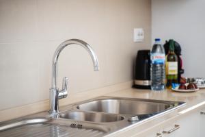 a stainless steel sink in a kitchen at Vistamar Apartments in Portimão