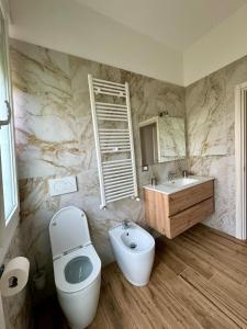 a bathroom with a toilet and a sink at Cristina's House in Ferrara +44 photos