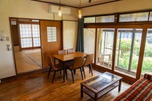 a living room with a table and chairs and a couch at Kinoie guesthouse 3rd buildingーVacation STAY 26705v in Mito