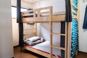 a bunk bed in a room with a ladder at Kinoie guesthouse 3rd buildingーVacation STAY 26705v in Mito