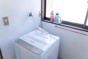 a washing machine in a room with a window at Kinoie guesthouse 3rd buildingーVacation STAY 26705v in Mito