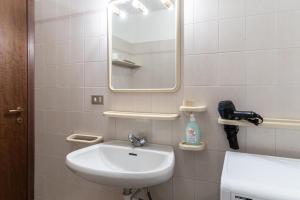 a bathroom with a sink and a mirror at Residenza Panarotta - Vetriolo(1500m) in Levico Terme +124 photos