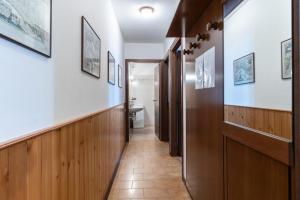 a hallway leading to a bathroom with a toilet at Residenza Panarotta - Vetriolo(1500m) in Levico Terme