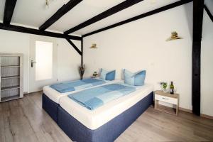 a bedroom with a large bed with blue pillows at Apartments am Schlosspark in Senftenberg