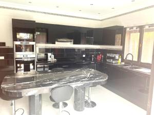 a large kitchen with a marble counter top at Splendide Villa, Marrakech in Marrakesh
