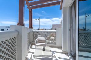 a balcony with two chairs and a table at Beach Walk Boutique Jumeirah in Dubai