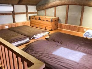 two beds in a room with wooden floors at gamo house - Vacation STAY 18292v in Sakaide