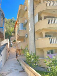 an apartment building with stairs leading up to it at Beach Bliss Apartment in Pržno