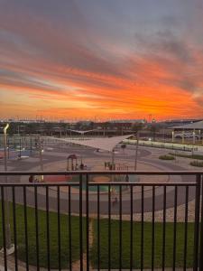 a sunset over a parking lot with a skate park at F1 Circuit View 1 Bd Apartment in Abu Dhabi