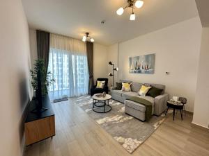 a living room with a couch and a table at Yas Island 1br By Skyhomes in Abu Dhabi