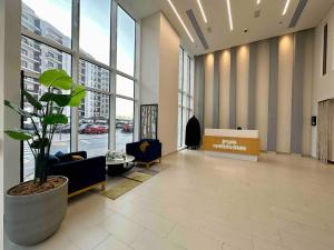 a lobby with a potted plant in a building at Yas Island 1br By Skyhomes in Abu Dhabi