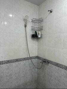 a shower with a shower head in a bathroom at Art's Family Guesthouse in Yerevan