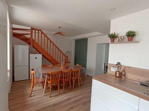 a kitchen and dining room with a table and chairs at gîte au champ d'avoine in Mauléon