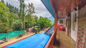 a balcony of a house with a swimming pool at Mir guest house in Pahalgām