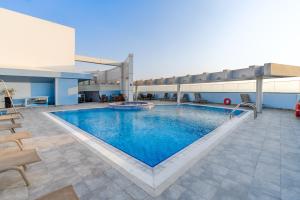a large swimming pool in a building with a pool at Montreal Barsha Hotel in Dubai