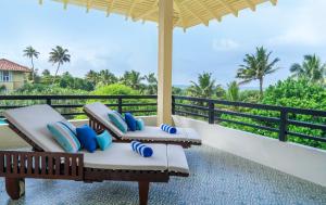 a balcony with lounge chairs and a view of the ocean at Heritance Ahungalla in Ahungalla