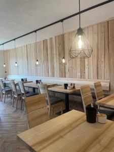 a restaurant with wooden walls and tables and chairs at Müller's Stuben in Isny im Allgäu