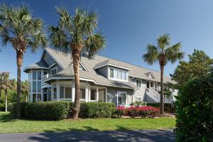 a house with palm trees in front of it at Kingston Plantation Condos in Myrtle Beach