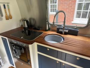 a kitchen counter with a sink and a sink at Airstream Experience in Knutsford