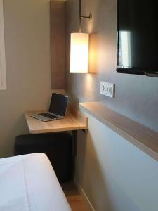 a laptop computer sitting on a desk in a room at ibis budget Ciboure St-Jean-Luz in Ciboure