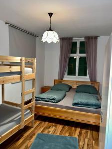 a bedroom with two bunk beds and a chandelier at Gästehaus Stern in Schwabach