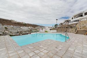 a large blue swimming pool in a building at Alohe Puertorico View in Puerto Rico de Gran Canaria
