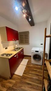 a kitchen with a sink and a washing machine at Gästehaus Stern in Schwabach