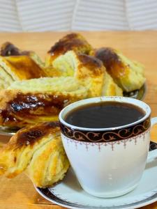 a plate with a cup of coffee and some food at LUCY B&B in Garni