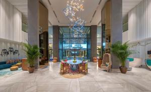 a lobby with a table and chairs in a building at Andaz by Hyatt – Palm Jumeirah in Dubai