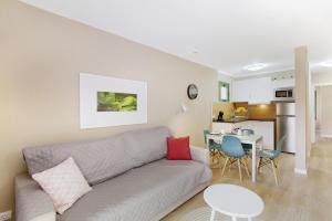 a living room with a couch and a table at Enjoy in Puerto Rico de Gran Canaria