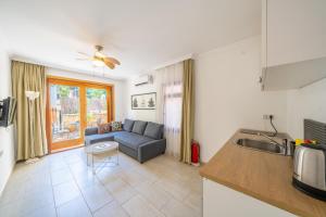 a kitchen and a living room with a couch at Yoga House Kaş in Kaş