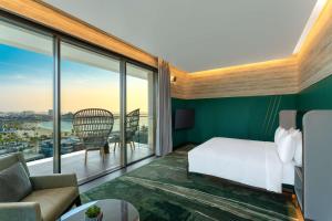 a hotel room with a bed and a large window at Hyatt Centric Jumeirah Dubai in Dubai