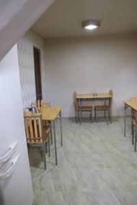 a dining room with wooden tables and chairs at Lucy in Garni