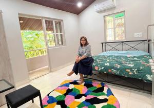 a woman standing on a bed in a room at Angel House -your private pet friendly haven in Lonavala