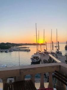 a group of boats parked in a marina with the sunset at Apartment Barbara in Supetar