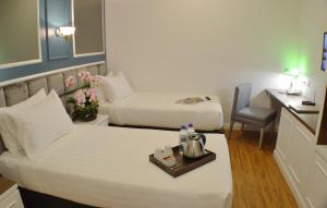 Postel nebo postele na pokoji v ubytování H Boutique Hotel Sri Petaling