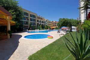a swimming pool with a frisbee next to a building at Yavor Palace Hotel - All Inclusive in Sunny Beach