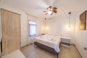 a bedroom with a bed and a ceiling fan at Yoga House Kaş in Kaş