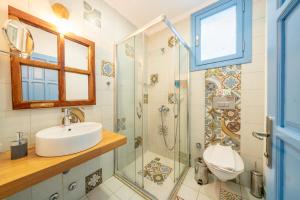 a bathroom with a sink and a shower at Yoga House Kaş in Kaş