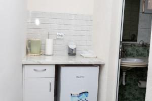 a bathroom with a sink and a counter with a appliance at Guest rooms and apartments Desi in Balchik +192 photos
