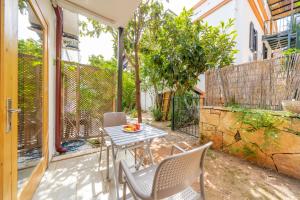 a patio with a table and chairs on a balcony at Yoga House Kaş in Kaş