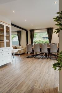 a living room with a dining room table and chairs at Traumfabrik Eifel mit Sauna & Whirlpool in Monschau
