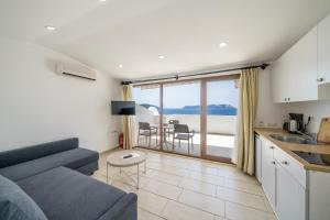 a living room with a couch and a kitchen with a view at Yoga House Kaş in Kaş