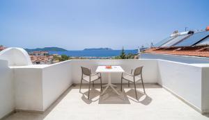 a small balcony with a table and chairs on a roof at Yoga House Kaş in Kaş