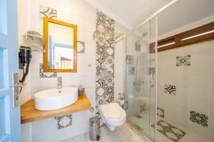 a bathroom with a toilet and a sink and a shower at Yoga House Kaş in Kaş