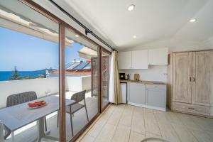 a kitchen with a table with a bowl of fruit on it at Yoga House Kaş in Kaş